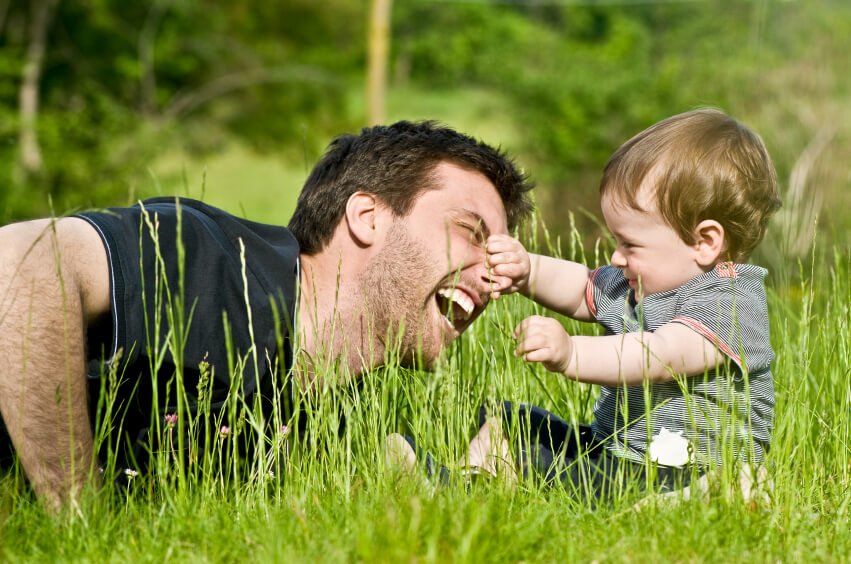 cute little child joke outdoor with dad