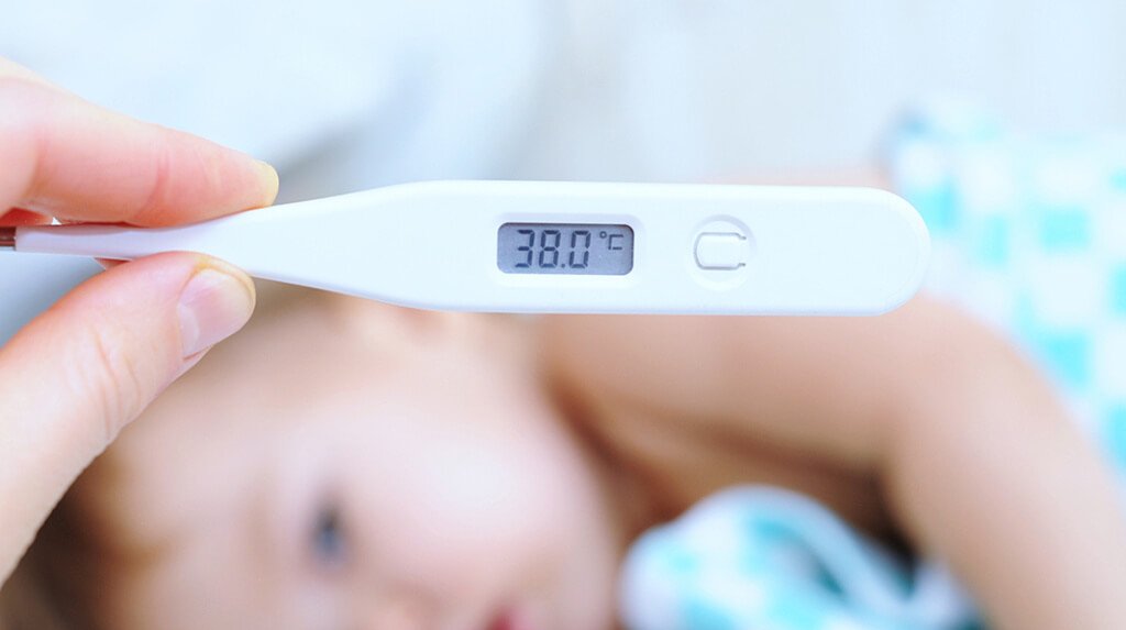 elevated temperature on thermometer of little baby child
