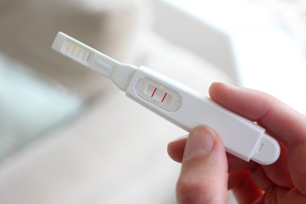 Woman holding a pregnancy test device