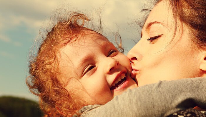 woman-kissing-little-girl