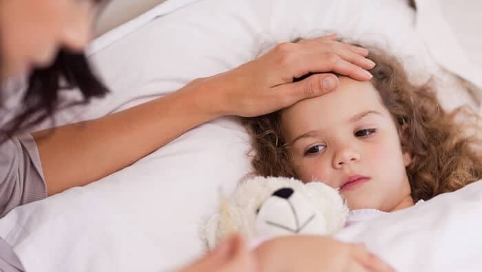 mother-with-hand-on-forehead-of-sick-child