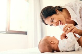 Shot of a happy mother bonding with her baby boy at home